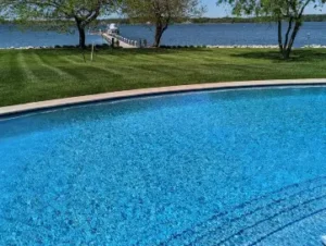 An arched pool with a large tanning ledge built by Coastal Pools in Maryland