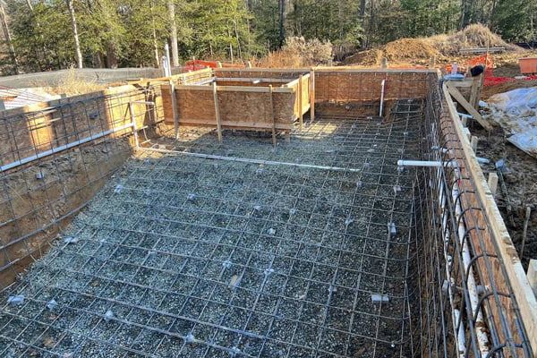 an inground swimming pool and attached spa being framed during the construction process