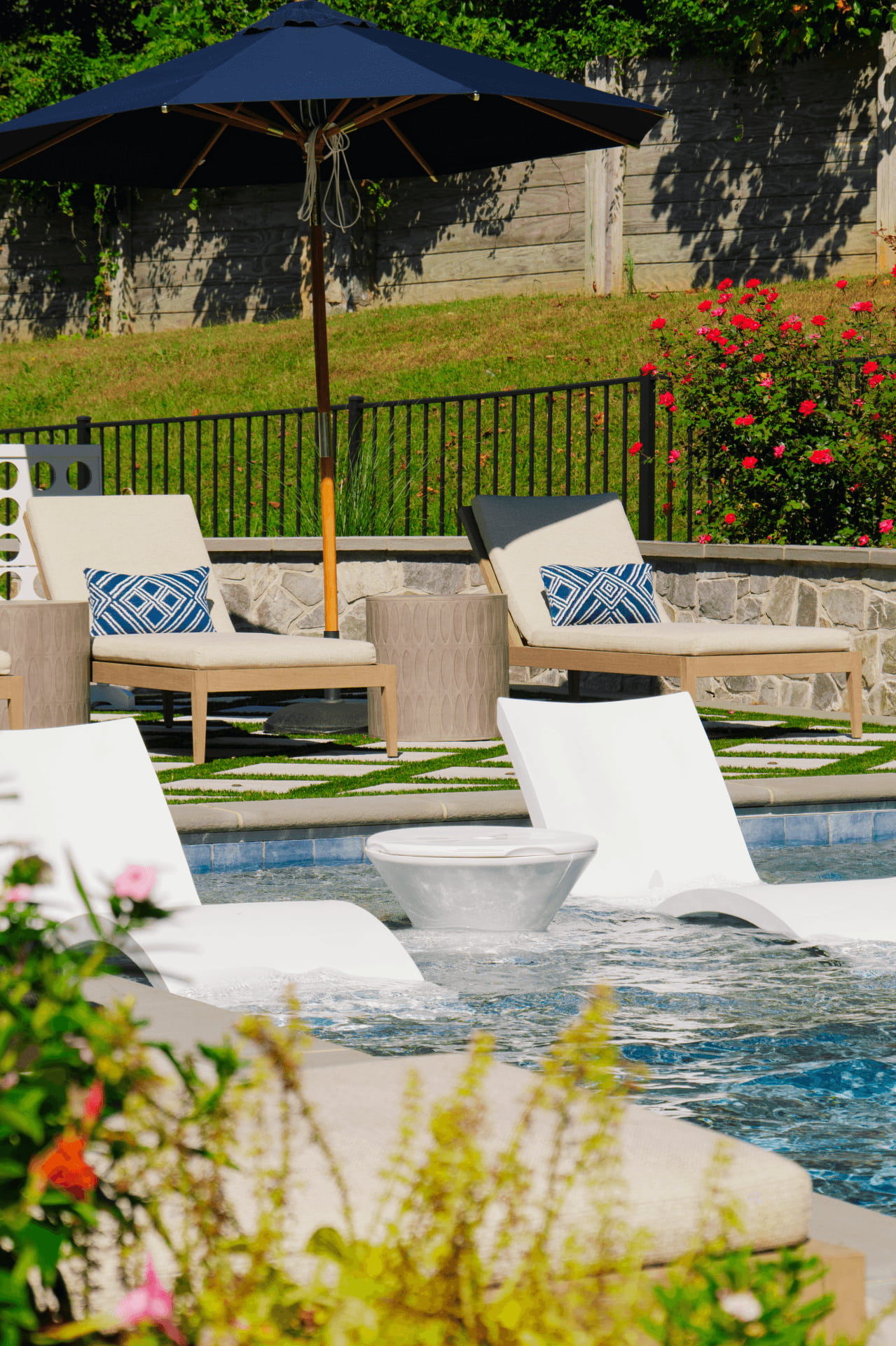 close-up of tanning ledge with some landscaping in foreground