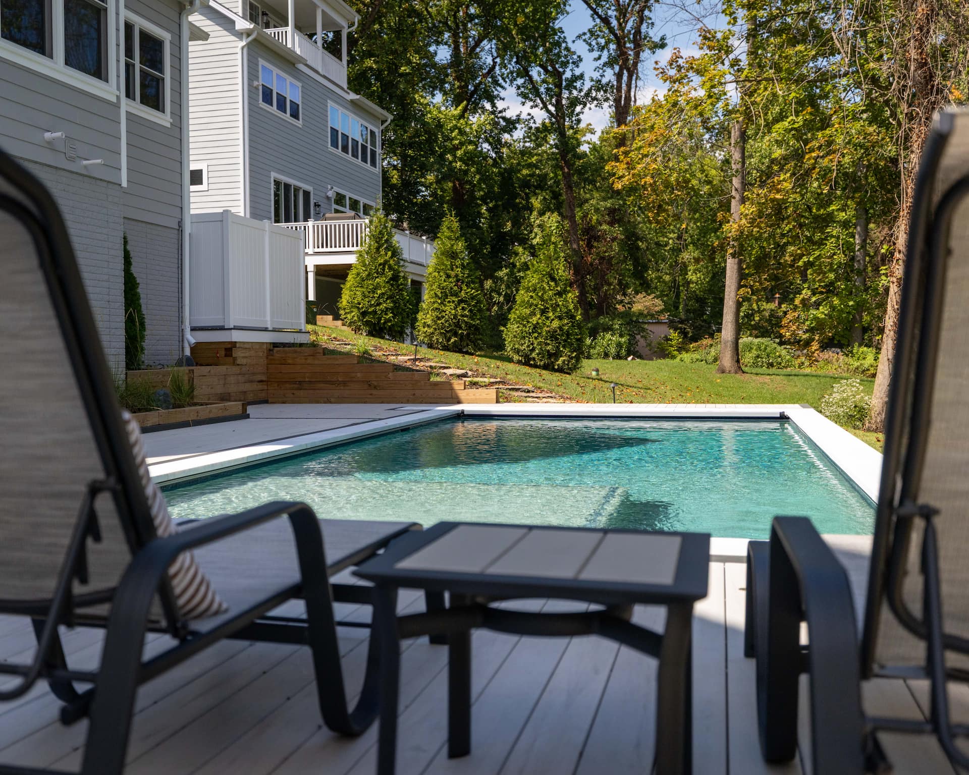 close up of geometric pool with deck chairs in the foreground