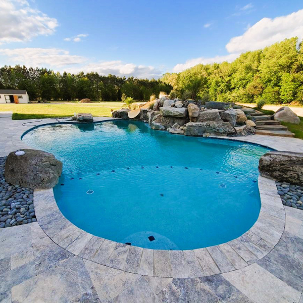 free form pool with waterfall and slide