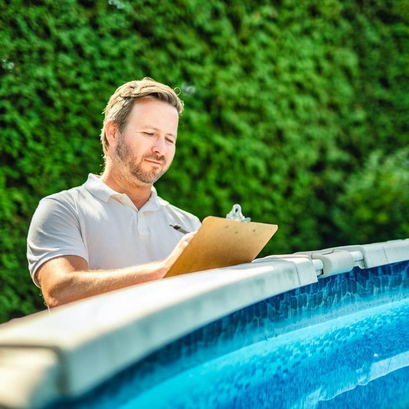 man inspecting the build of swimming pool