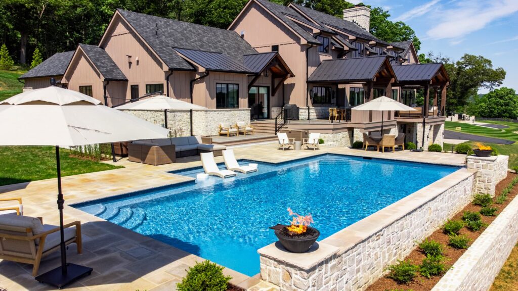 Modern house with a pool, patio, and fire pit